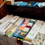 A selection of stoles and dalmatics are laid out.